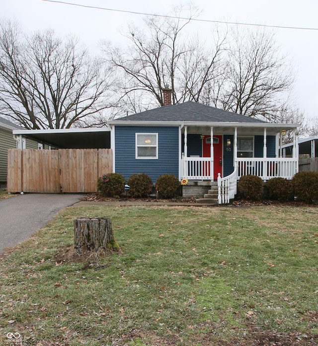 view of front of home featuring covered porch, a carport, and a front yard