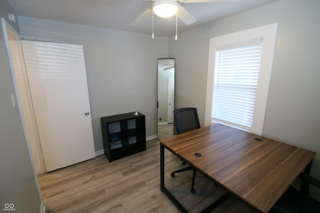 office area with light wood-type flooring and ceiling fan