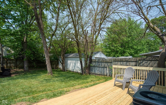 deck with a yard and central air condition unit