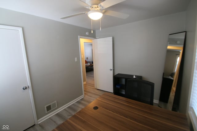 interior space with hardwood / wood-style flooring and ceiling fan