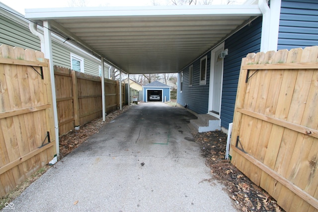 view of patio / terrace featuring a carport and an outbuilding