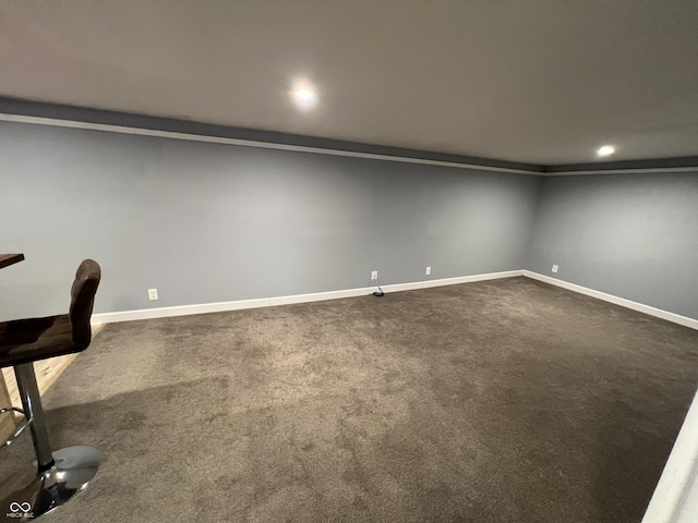 basement featuring dark carpet