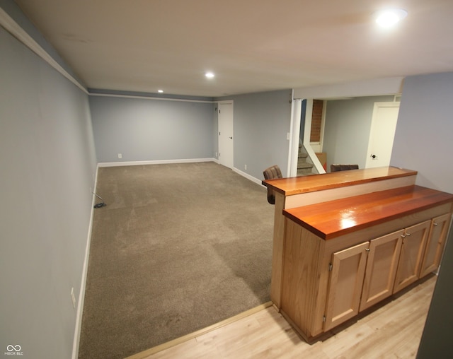 bar with light colored carpet and wood counters