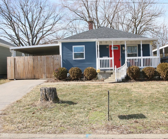 view of front of house with a front lawn, a carport, and a porch