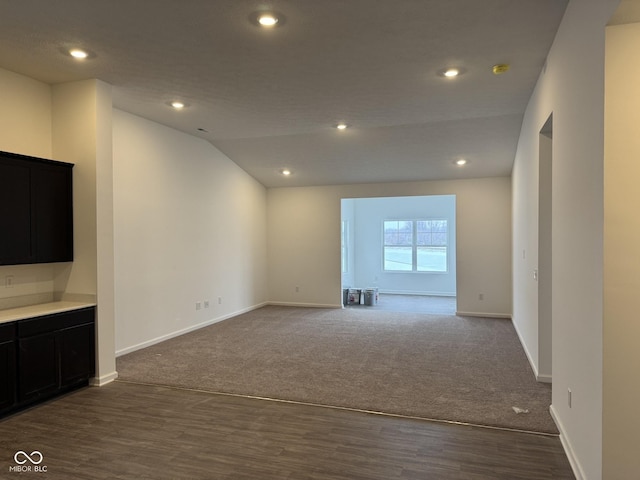 unfurnished living room featuring lofted ceiling and carpet floors