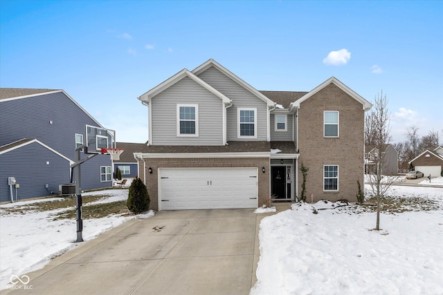 view of property featuring a garage and central AC unit