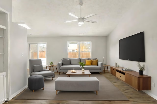 living room with ceiling fan and light hardwood / wood-style flooring