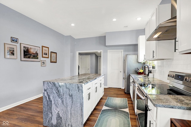 kitchen featuring white cabinetry, stainless steel range with electric stovetop, dark hardwood / wood-style flooring, light stone countertops, and wall chimney range hood