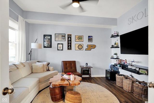 living room with ceiling fan, plenty of natural light, and dark hardwood / wood-style flooring