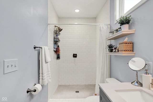 bathroom featuring vanity, curtained shower, and toilet