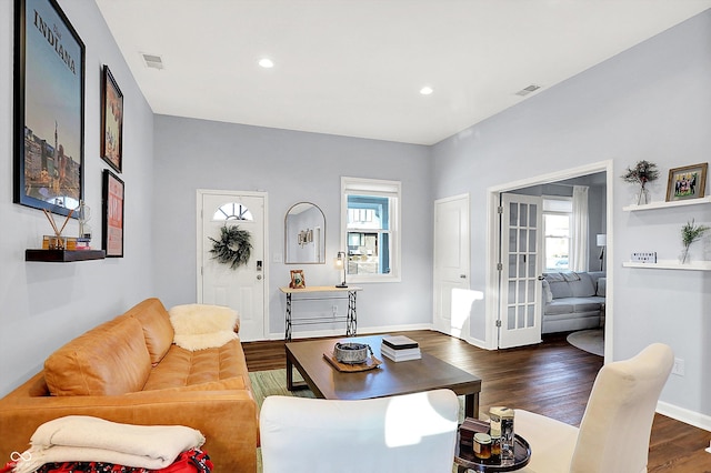 living room with a wealth of natural light and dark hardwood / wood-style floors