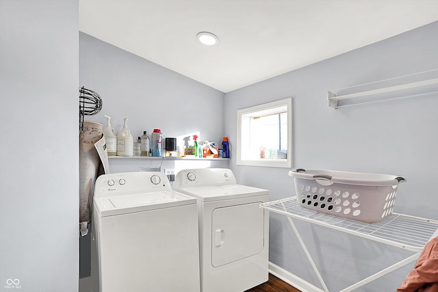 clothes washing area with separate washer and dryer and dark hardwood / wood-style floors