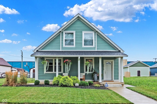 bungalow-style house with a front lawn and a porch