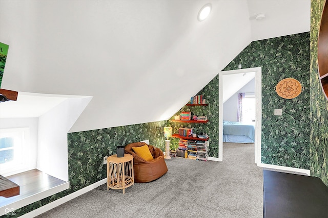 interior space featuring vaulted ceiling and carpet floors