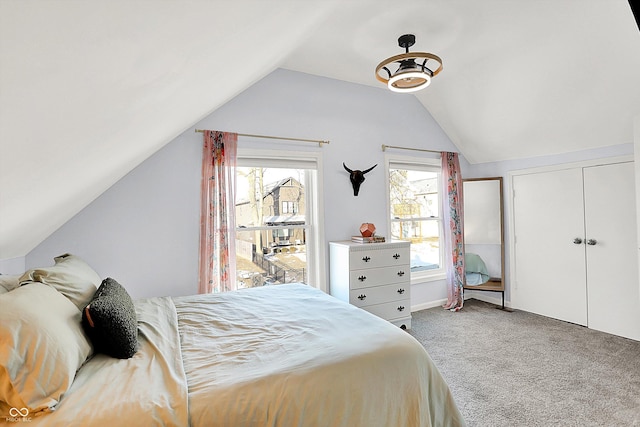 carpeted bedroom featuring vaulted ceiling