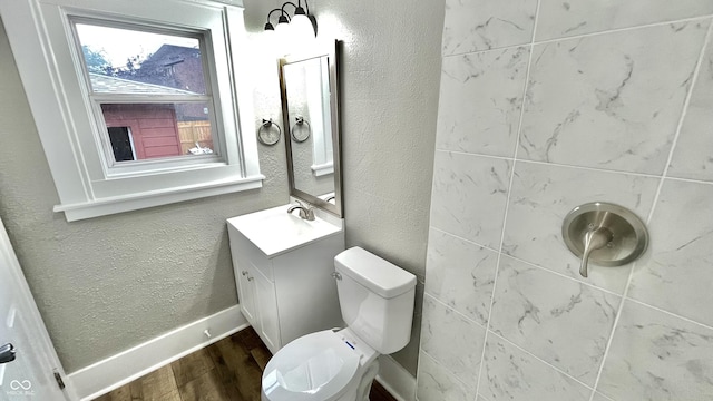 bathroom with vanity, toilet, and wood-type flooring