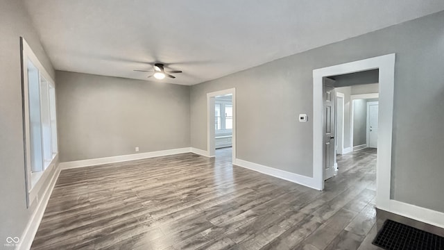 spare room featuring ceiling fan and dark hardwood / wood-style floors