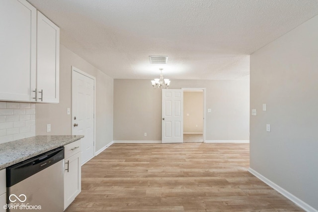 kitchen featuring white cabinetry, dishwasher, light stone counters, and light hardwood / wood-style floors