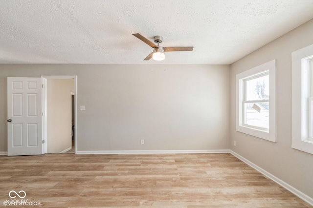 unfurnished room with ceiling fan, light hardwood / wood-style floors, and a textured ceiling