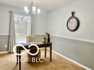 carpeted home office with a notable chandelier and a healthy amount of sunlight