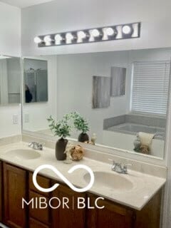 bathroom featuring a tub to relax in and vanity