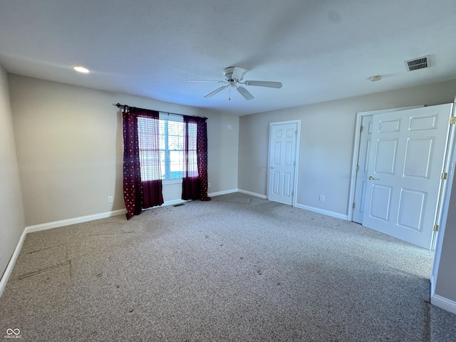 carpeted spare room featuring ceiling fan