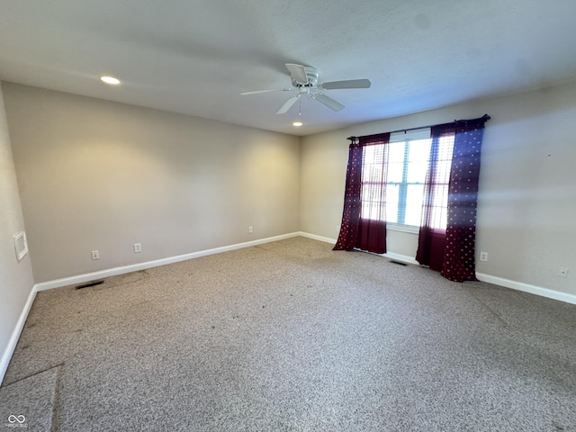 carpeted spare room with ceiling fan