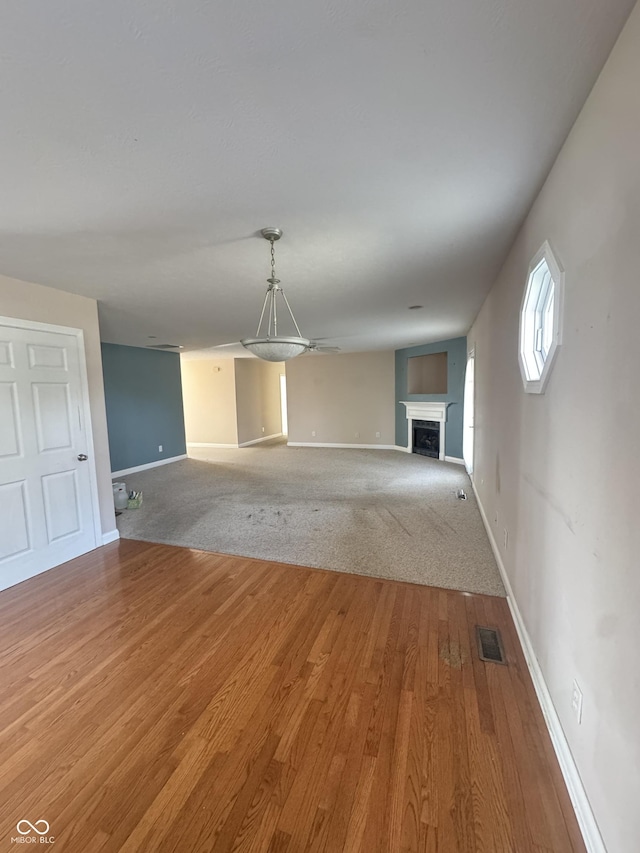 unfurnished living room with hardwood / wood-style floors