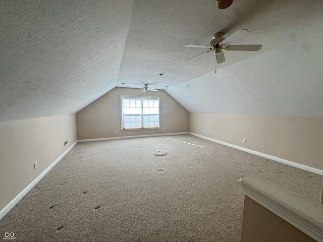 bonus room featuring vaulted ceiling, carpet floors, and a textured ceiling