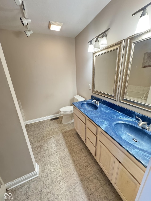 bathroom with vanity and toilet