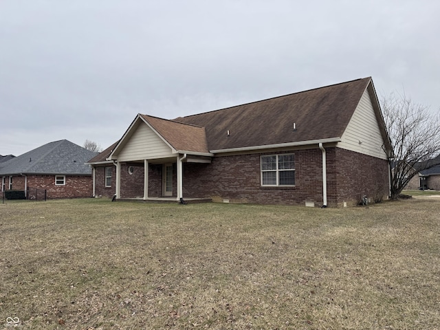 rear view of property featuring a yard