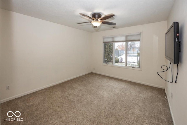 empty room featuring ceiling fan and carpet flooring