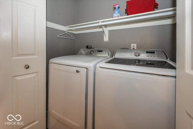 clothes washing area featuring washer and dryer