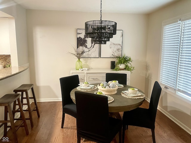 dining room featuring an inviting chandelier and dark hardwood / wood-style flooring