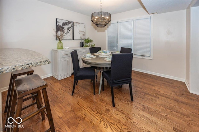 dining room with a notable chandelier and light wood-type flooring