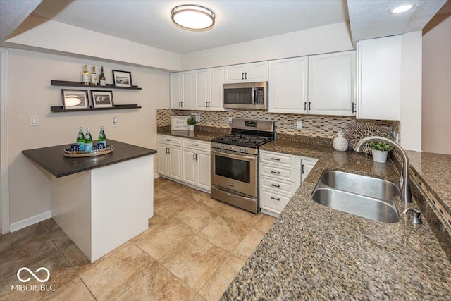 kitchen with sink, white cabinetry, backsplash, stainless steel appliances, and kitchen peninsula