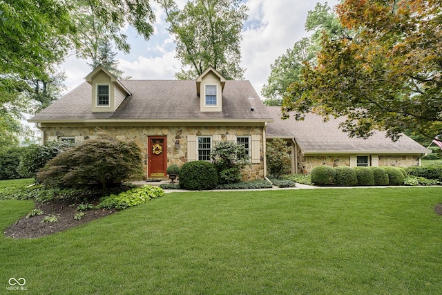 cape cod home with a front lawn