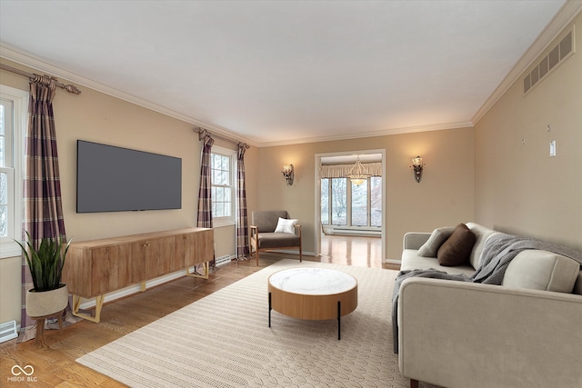 living room featuring hardwood / wood-style flooring and crown molding