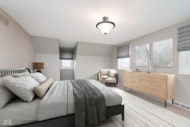 carpeted bedroom with vaulted ceiling