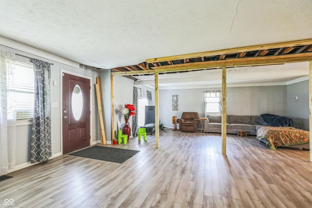 foyer with a textured ceiling and light wood-type flooring