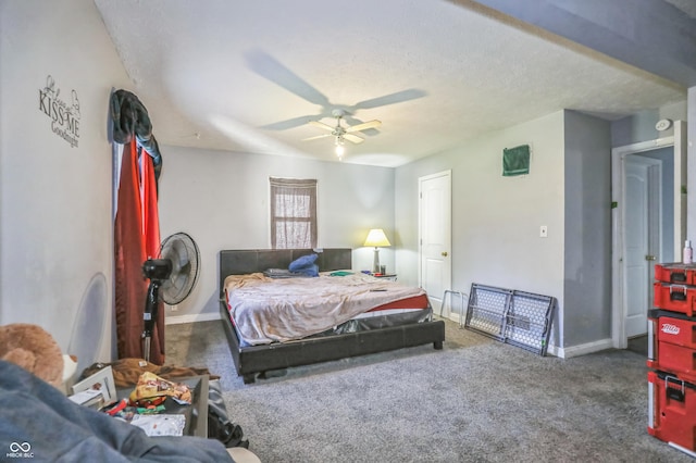 carpeted bedroom featuring ceiling fan and a textured ceiling