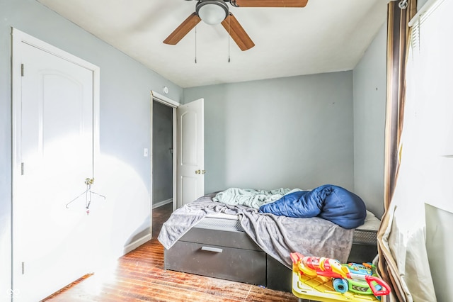 bedroom with hardwood / wood-style flooring and ceiling fan