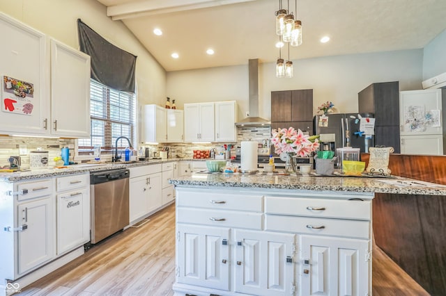 kitchen with white cabinetry, stainless steel appliances, and wall chimney range hood