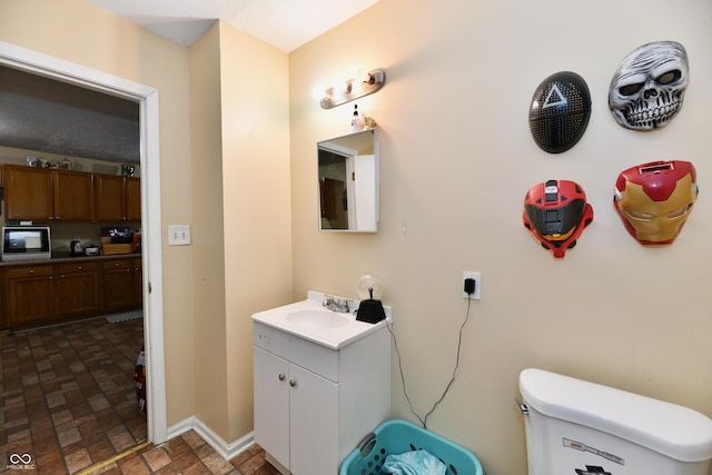 bathroom with toilet and vanity