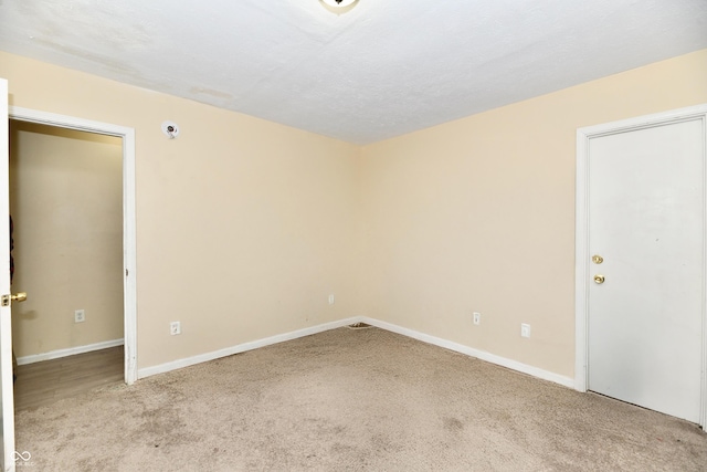 unfurnished room with light colored carpet