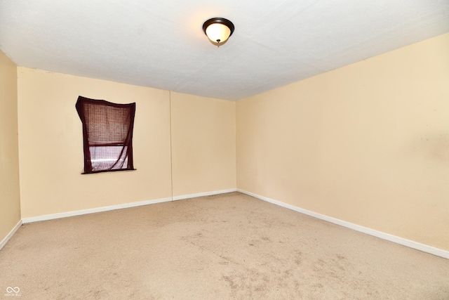 carpeted empty room with a textured ceiling