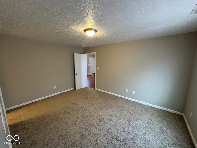 carpeted spare room with a textured ceiling