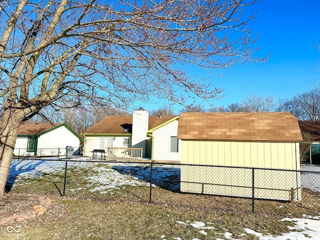 view of snow covered exterior with a storage shed