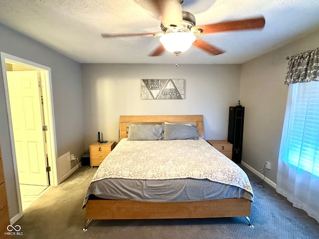 carpeted bedroom with a textured ceiling and ceiling fan