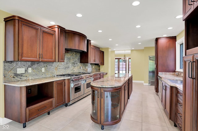 8602 Frontgate Ln, Indianapolis, IN 46256 - kitchen featuring double oven range, a center island, recessed lighting, decorative backsplash, and light stone countertops